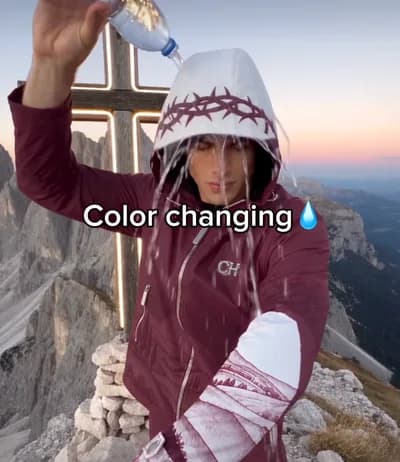Water poured over a color-changing hoodie on a mountain